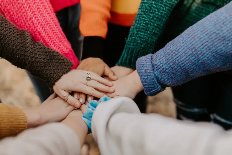 Hands on top of each other in circle