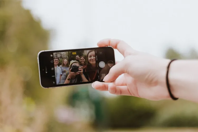 Photo of people taking a selfie on phone