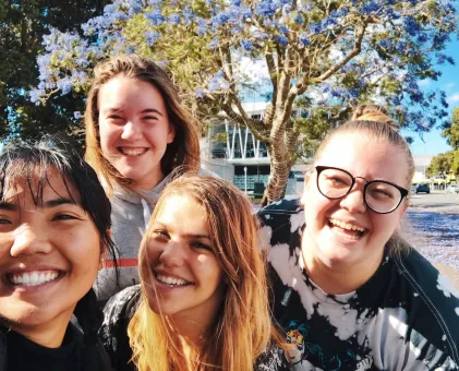 4 women looking at camera smiling