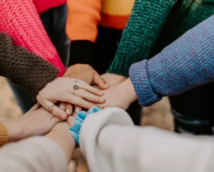 Hands on top of each other in circle